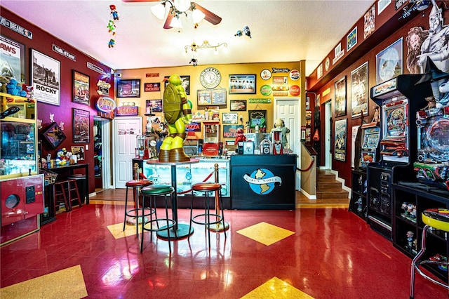 recreation room featuring ceiling fan and a textured ceiling