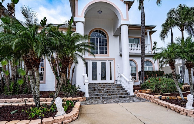 mediterranean / spanish home featuring french doors and a balcony