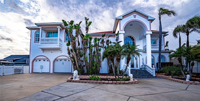 view of front of house featuring a garage and a balcony