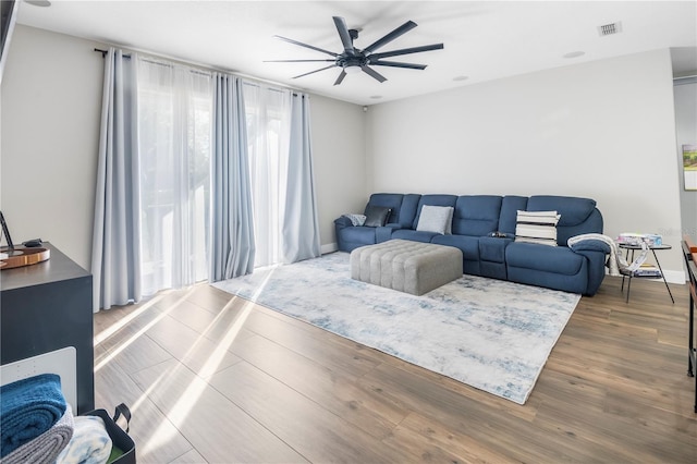 living room featuring hardwood / wood-style flooring and ceiling fan