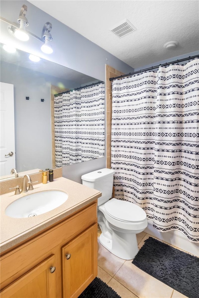 bathroom with curtained shower, tile patterned flooring, vanity, and toilet