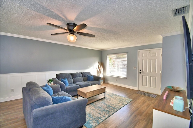 living room featuring ceiling fan, crown molding, and dark hardwood / wood-style floors