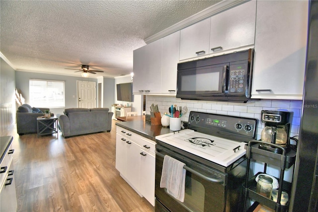 kitchen featuring white cabinetry, black appliances, and ornamental molding