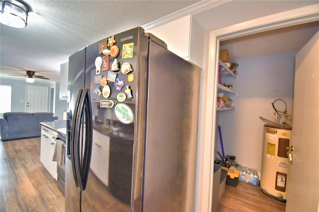 kitchen with ceiling fan, stainless steel fridge with ice dispenser, electric water heater, a textured ceiling, and hardwood / wood-style flooring