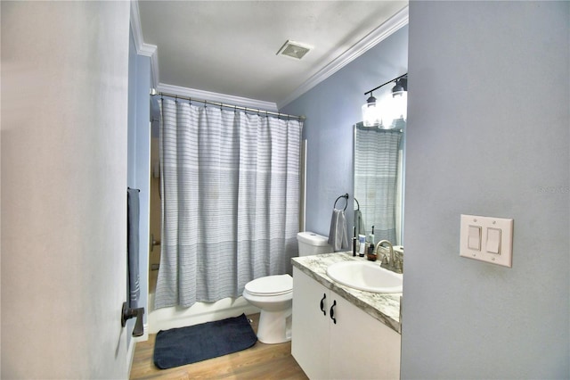 full bathroom featuring ornamental molding, vanity, shower / bath combo with shower curtain, hardwood / wood-style flooring, and toilet