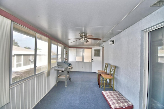 sunroom / solarium featuring ceiling fan