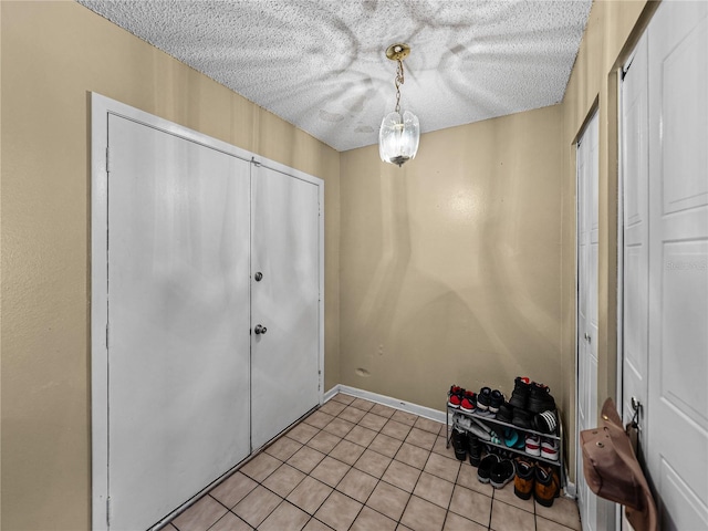 tiled entrance foyer with a textured ceiling