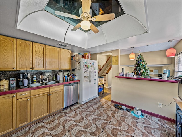 kitchen with stainless steel dishwasher, ceiling fan, sink, white fridge with ice dispenser, and hanging light fixtures