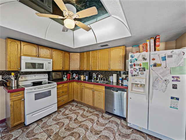 kitchen with backsplash, ceiling fan, white appliances, and sink