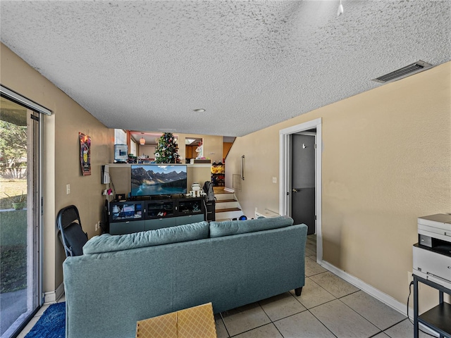 living room with light tile patterned floors and a textured ceiling