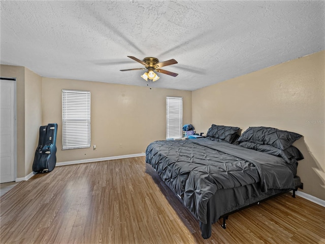 bedroom featuring a textured ceiling, hardwood / wood-style flooring, and ceiling fan