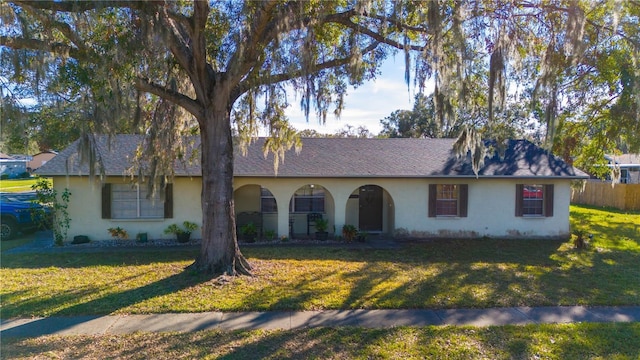 ranch-style home with a front yard