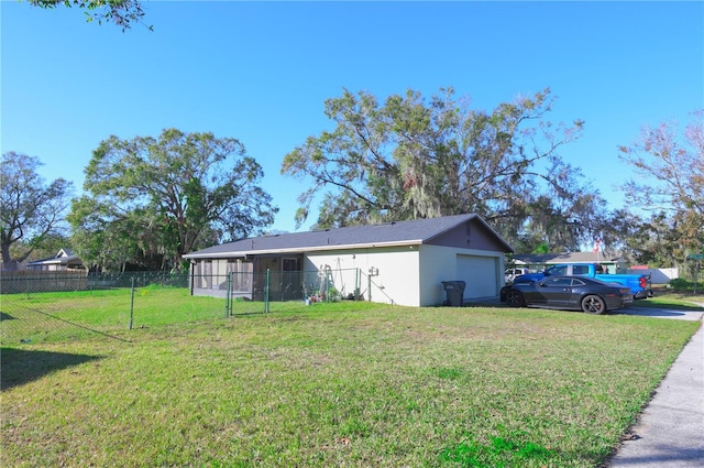 exterior space featuring a lawn and a garage