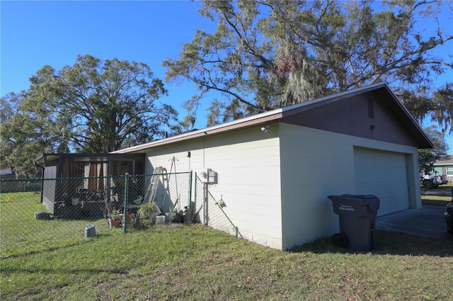 view of side of property featuring a garage and a yard