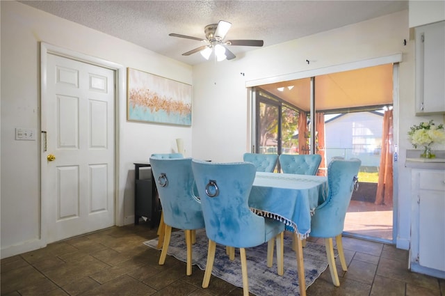 dining space with ceiling fan and a textured ceiling