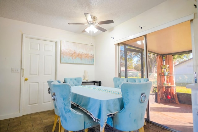 dining area featuring a textured ceiling, plenty of natural light, and ceiling fan