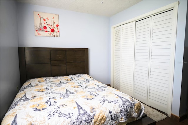 bedroom with a textured ceiling and a closet