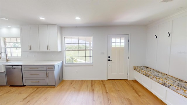 kitchen featuring dishwasher, light wood-type flooring, white cabinets, and gray cabinetry