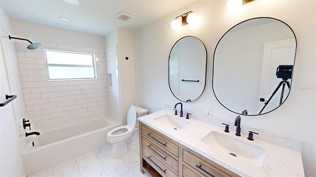 full bathroom featuring vanity, tiled shower / bath, and toilet