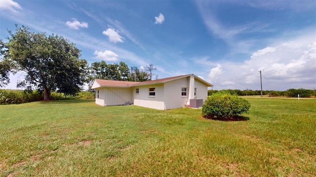 exterior space with a yard and central air condition unit