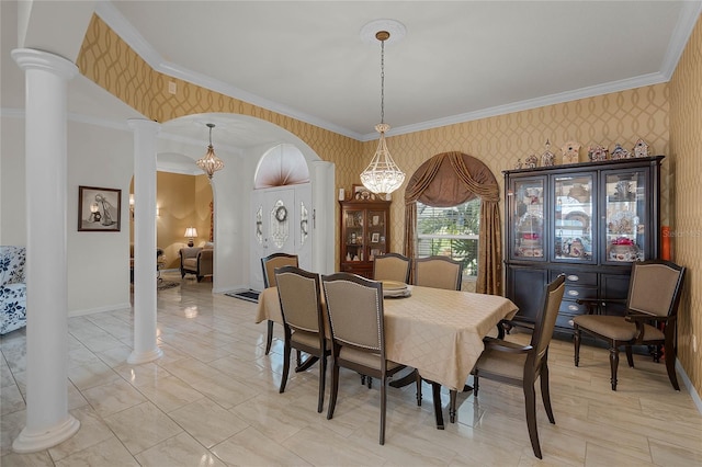 dining space featuring decorative columns, ornamental molding, and an inviting chandelier