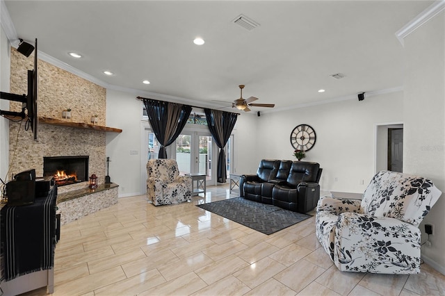 living room featuring ceiling fan, ornamental molding, french doors, and a stone fireplace