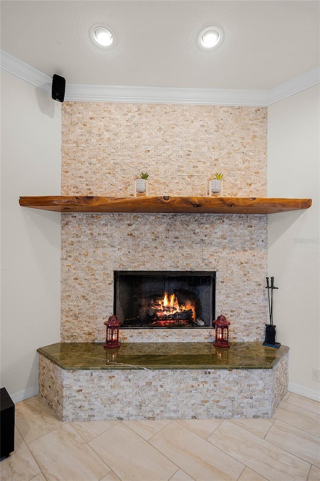 interior details with ornamental molding and a fireplace