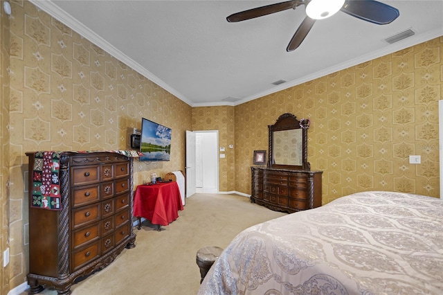 carpeted bedroom featuring ceiling fan and crown molding