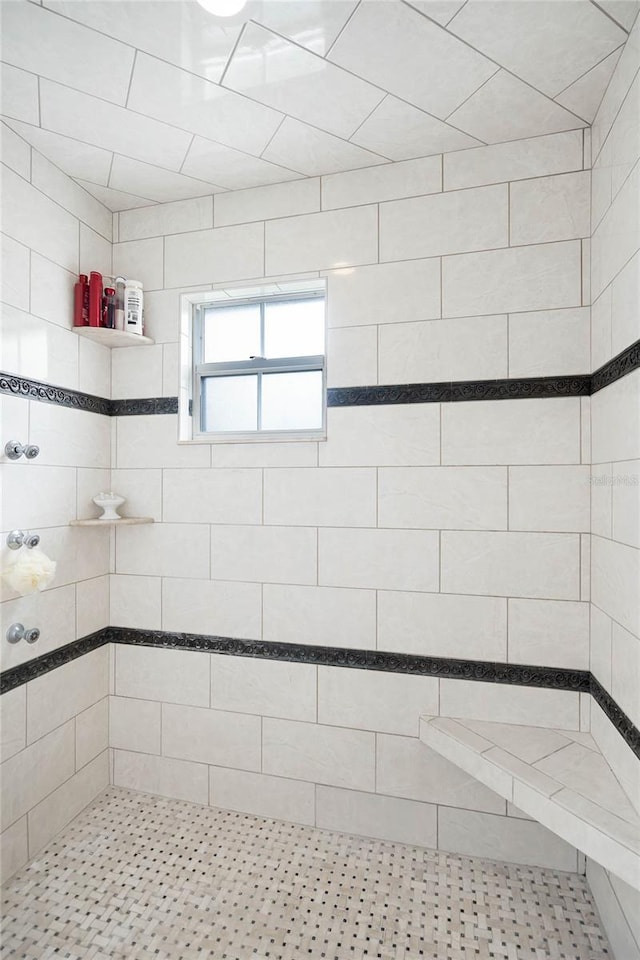 bathroom with a tile shower