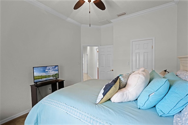 carpeted bedroom featuring ceiling fan and crown molding