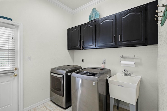 clothes washing area featuring washing machine and dryer, cabinets, sink, ornamental molding, and light tile patterned flooring