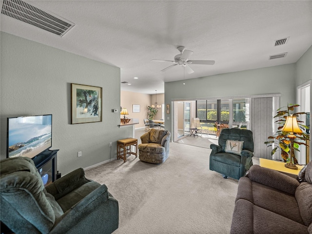 living room featuring carpet floors, a textured ceiling, and ceiling fan