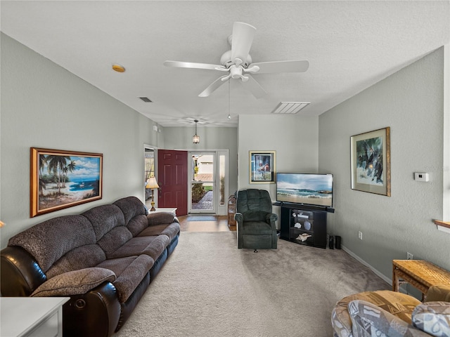 carpeted living room featuring ceiling fan