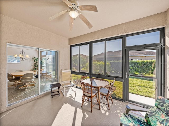 sunroom / solarium with ceiling fan with notable chandelier