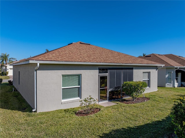 rear view of house featuring a yard