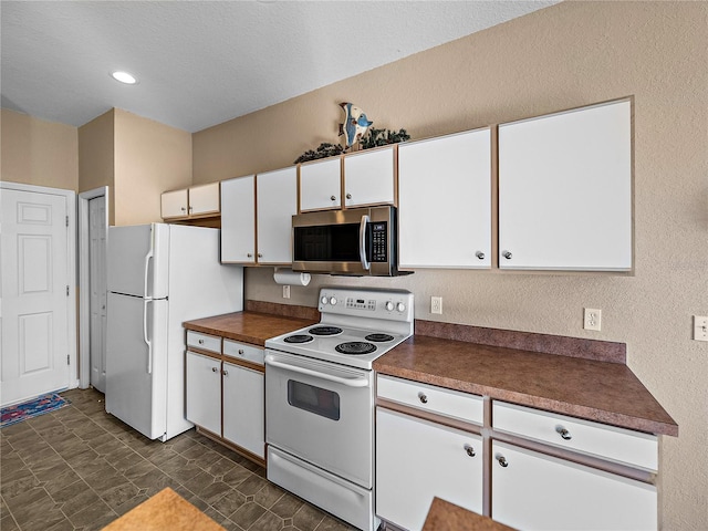 kitchen with white appliances and white cabinets