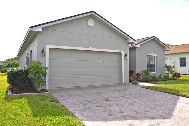 ranch-style house with a garage and a front yard