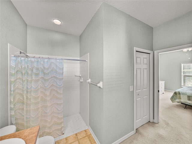 bathroom with vanity, a textured ceiling, toilet, and a shower with shower curtain