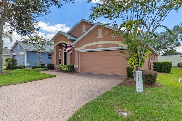 view of front of home featuring a garage and a front yard