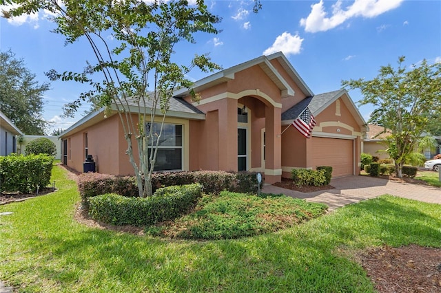 view of front of property featuring a front yard and a garage