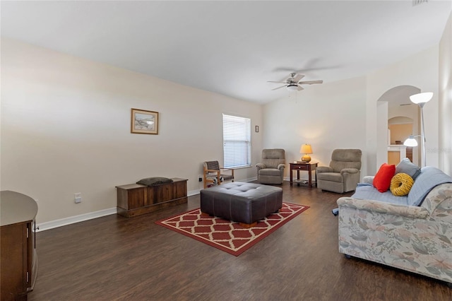 living room with dark hardwood / wood-style flooring and ceiling fan