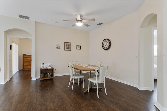 dining area with ceiling fan and dark wood-type flooring