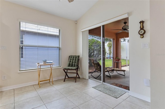 sitting room with light tile patterned floors, a wealth of natural light, and vaulted ceiling