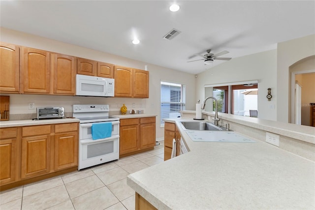 kitchen featuring white appliances, ceiling fan, sink, light tile patterned floors, and lofted ceiling