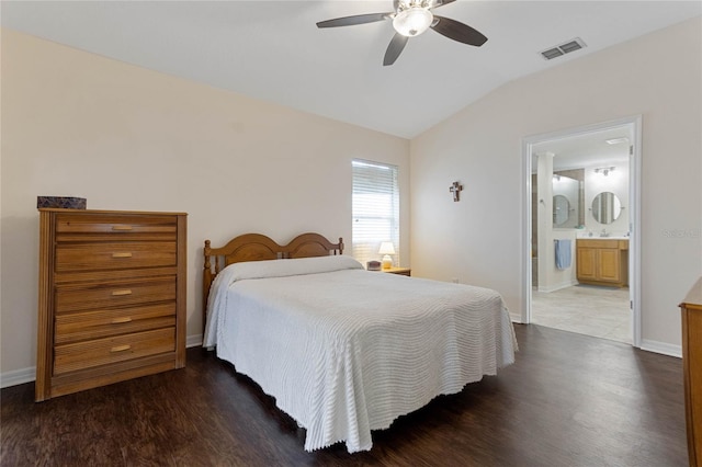 bedroom featuring connected bathroom, ceiling fan, dark hardwood / wood-style flooring, and vaulted ceiling