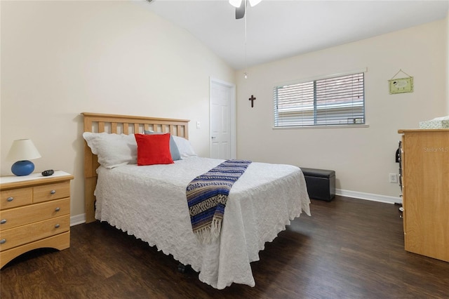 bedroom with dark hardwood / wood-style flooring, vaulted ceiling, and ceiling fan