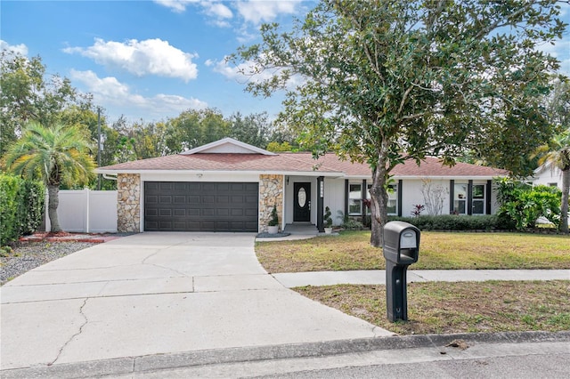 ranch-style home with a garage and a front lawn