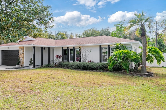 ranch-style home with a front lawn and a garage