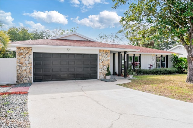 single story home with a front yard and a garage