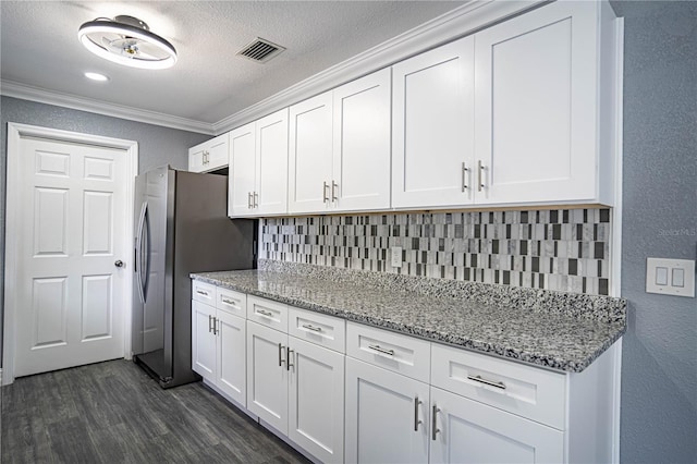 kitchen with decorative backsplash, white cabinetry, ornamental molding, and stainless steel refrigerator with ice dispenser